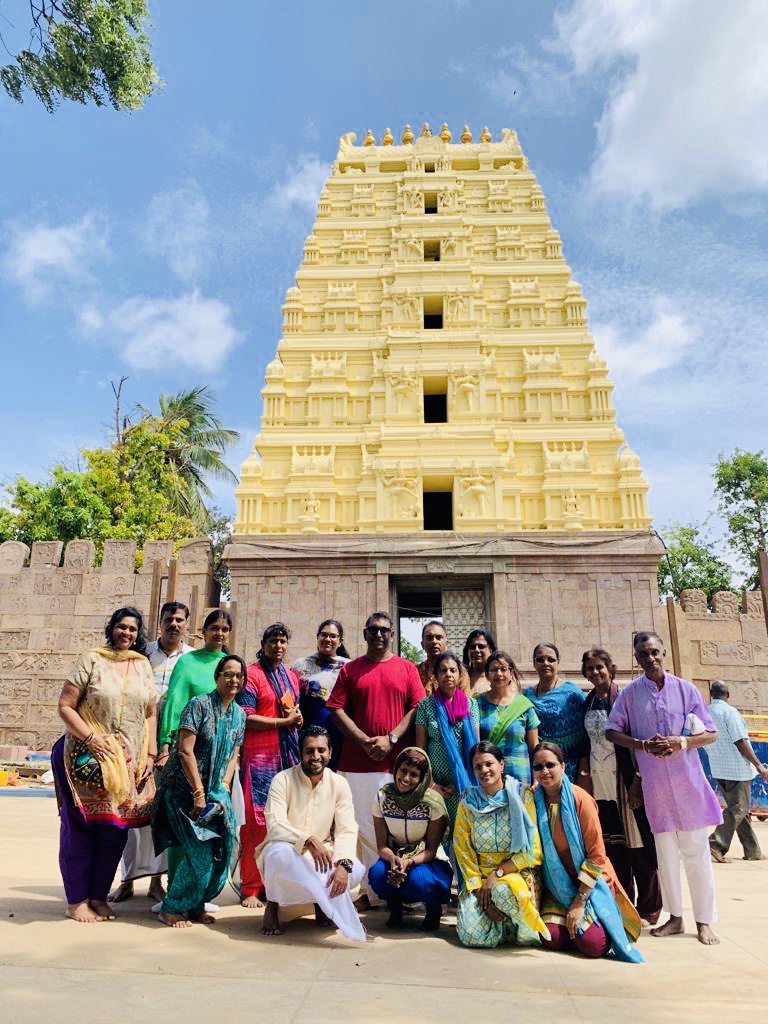 Raiinbow Tours & Travels group in front of a golden temple gopuram